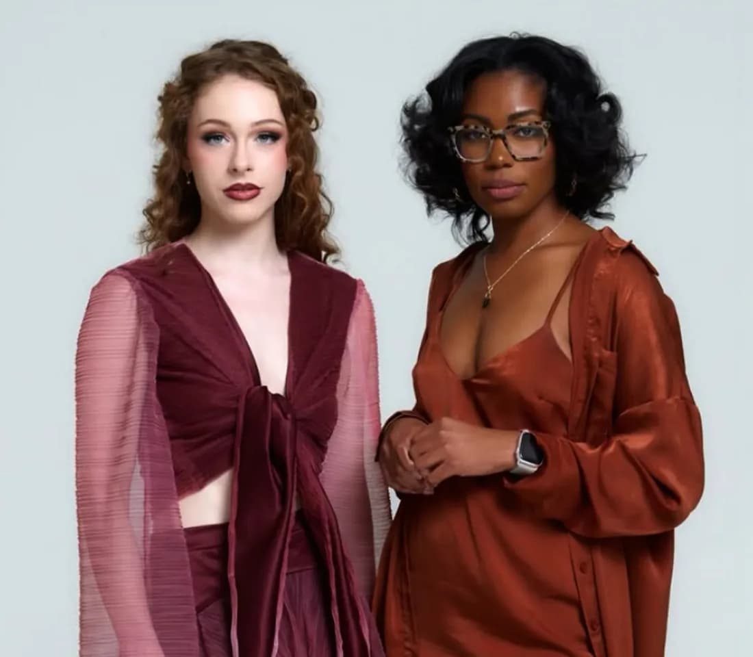 Two models presenting designer looks — a sheer-sleeve maroon top and a satin rust-toned outfit
