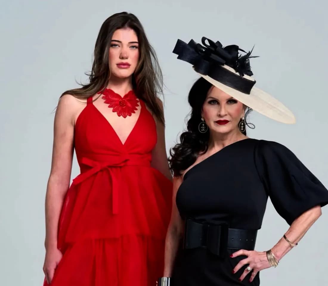 Two models presenting designer looks — a red gown with floral detail and a black one-shoulder dress with a wide-brim statement hat